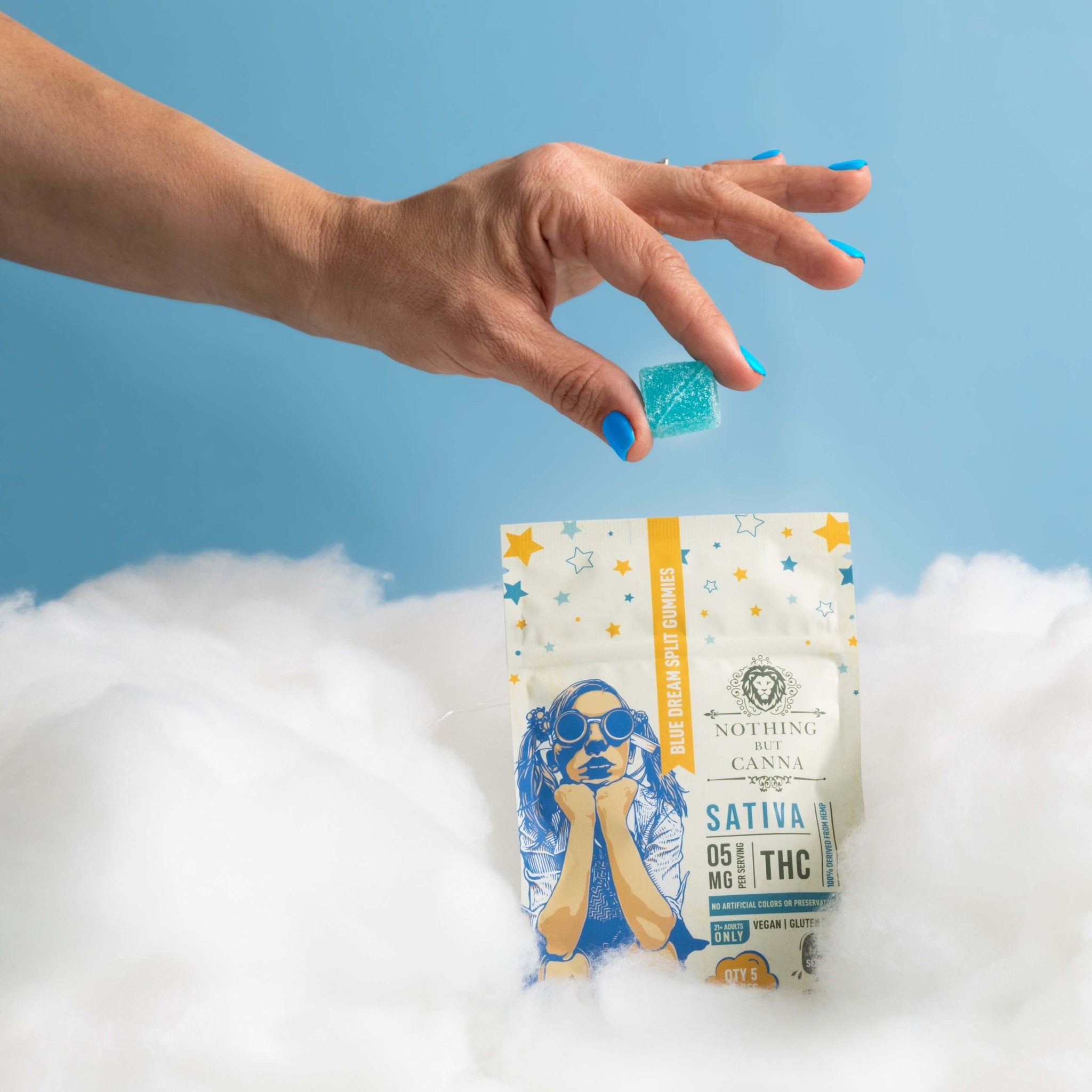 Nothing But Hemp Blue Dream hemp-derived delta-9 THC sativa gummies bag sitting in clouds against a sky blue background with a hand reaching in holding a gummy above the product