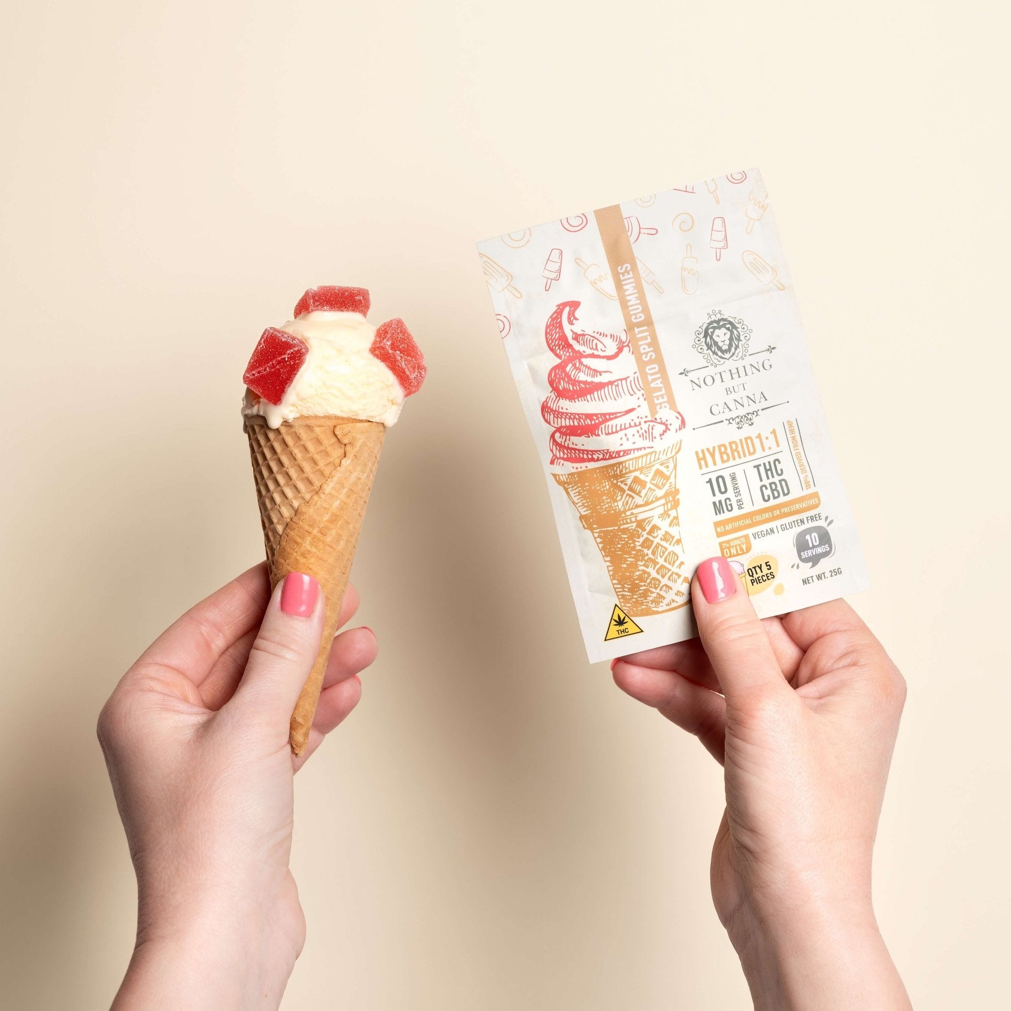 Hand with pink fingernails holding Nothing But Hemp Gelato THC and CBD hybrid gummies package while another hand with pink fingernails holds a vanilla ice cream cone topped with gummies, styled on a matching vanilla background with gelato-inspired theme