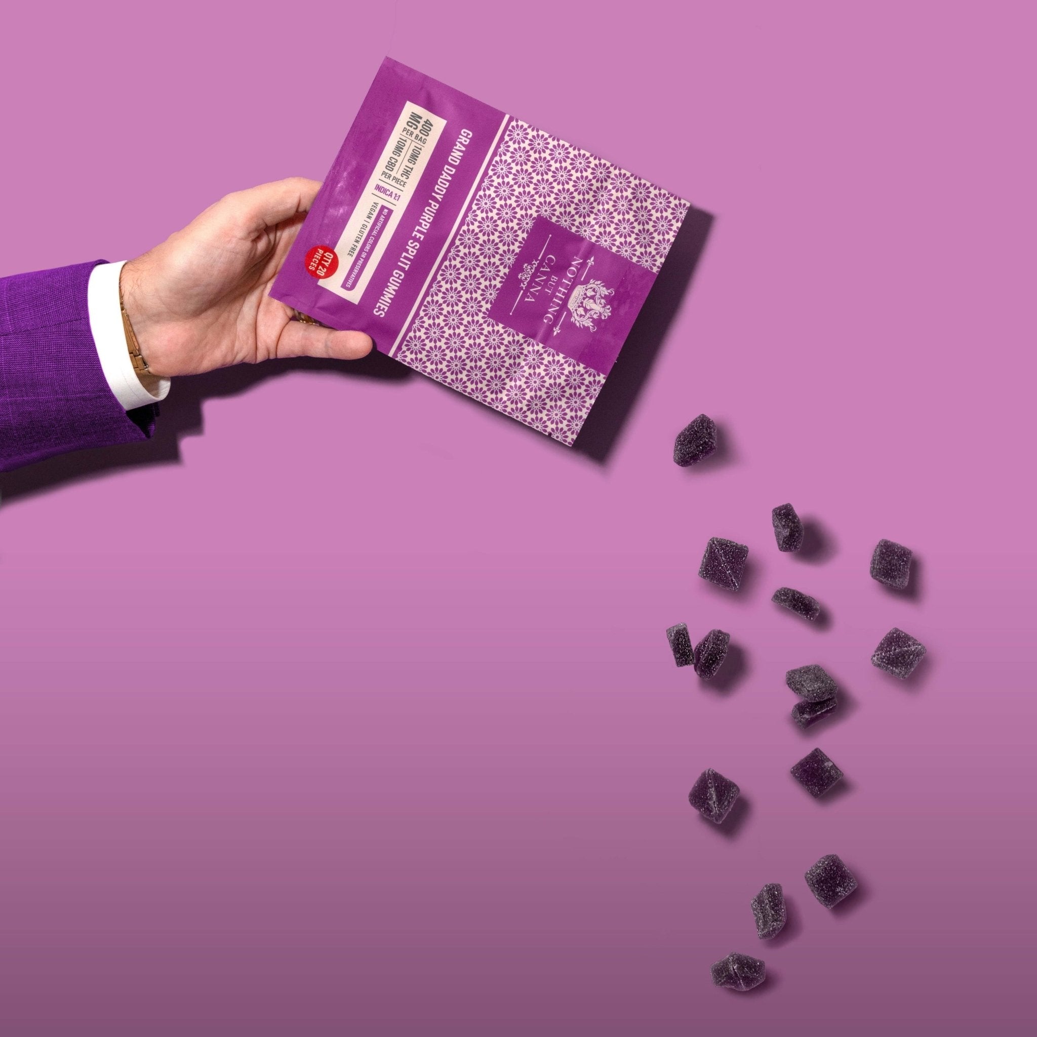 Nothing But Hemp Grand Daddy Purple hemp-derived THC and CBD indica gummies with model in purple suit pouring gummies from the package against a purple background, showing product and sleeve in a styled lifestyle scene